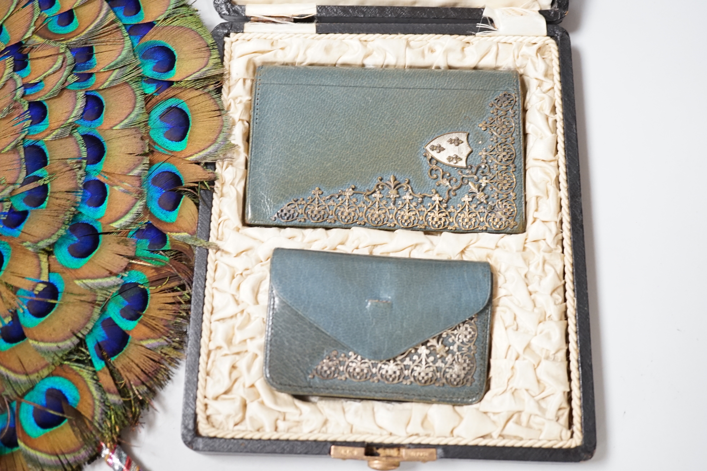 A 19th century peacock feather fan, a cut steel bag and a cased leather and silver mounted purse and card case, fan 41cm high